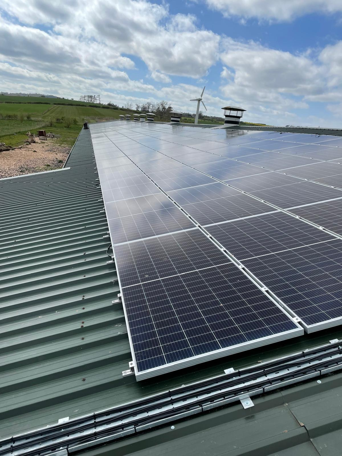 Solar PV Installation: roof-mounted solar PV array installed on an agricultural building in the Scottish Borders