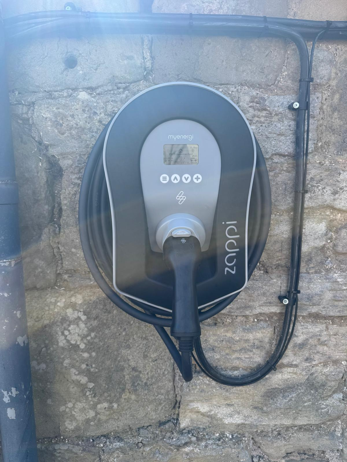 EV Charging Installation: myenergi Zappi EV charge point installed on a stone wall by WPP Electrical