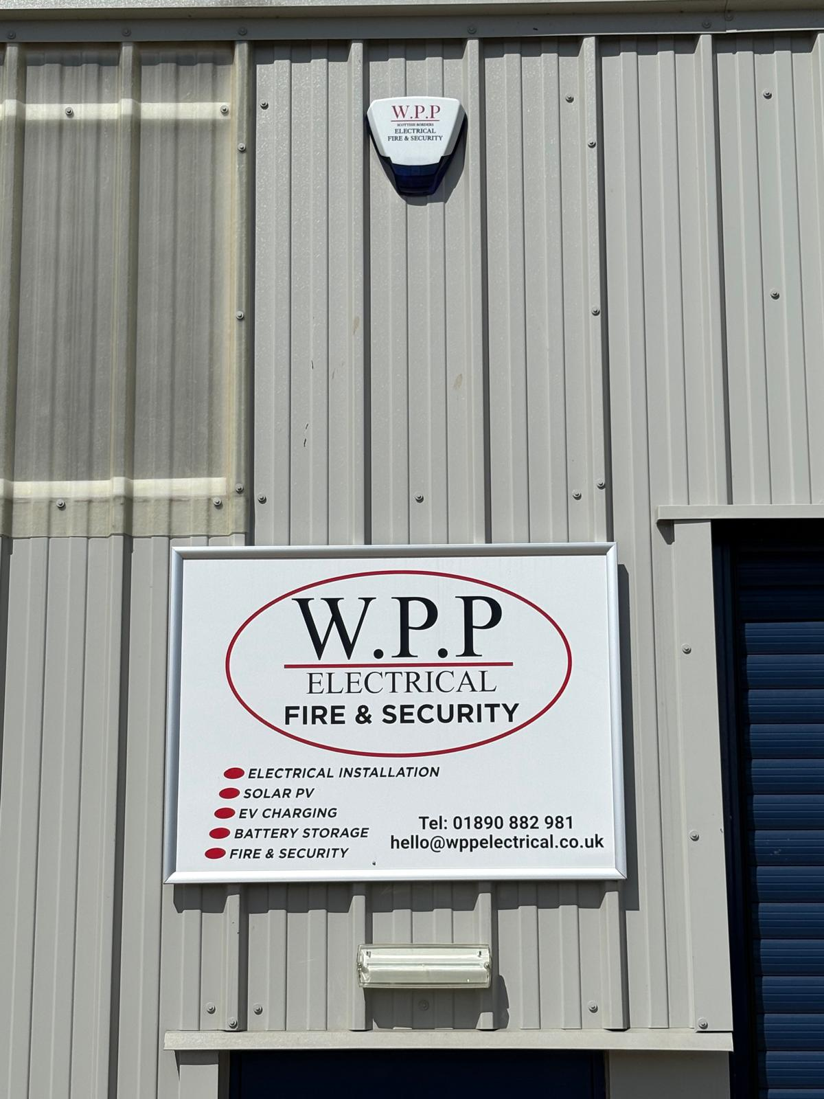 Security & CCTV Installation: external alarm sounder and WPP Electrical Fire & Security signage on a commercial unit in the Scottish Borders